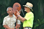 Jon Conching, team captain, accepts the award from Bob Hampton, President of Waikiki Beach Activities, on behalf of Hilton Hawaiiain Village, winner of the SUP race.